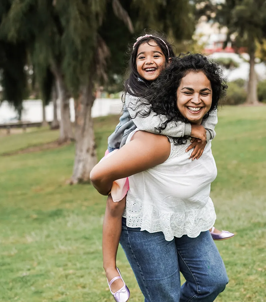 Parent carrying child outdoors